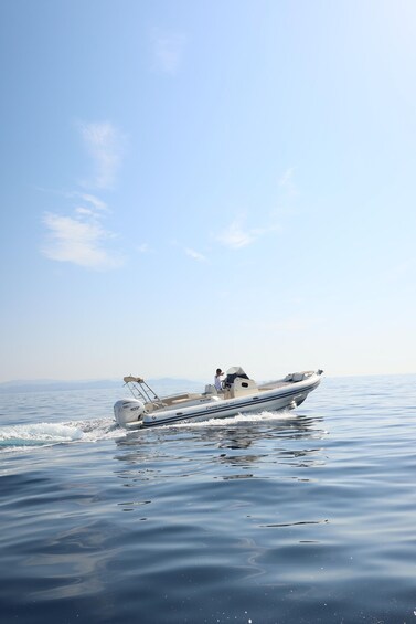 A motorboat on calm water with a clear sky. 3