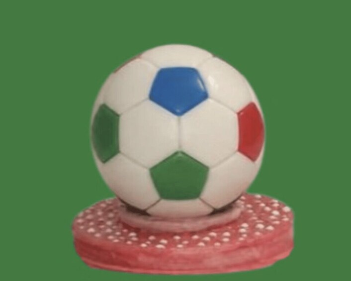 A soccer ball on a red base with white dots. 2