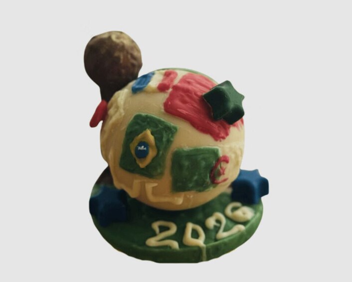 A colorful figurine with a brown head, green and red clothing, and blue accents. 3