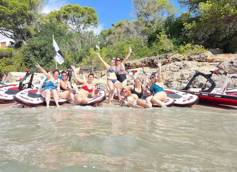 A group of people on watercraft in a natural setting with trees and rocks. 1