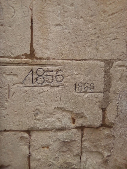 A stone wall with the numbers '1856' and '1856' carved into it. 3