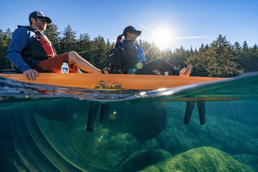 Two people kayaking on a clear day with the sun shining. 2