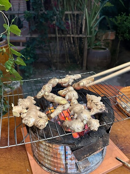 Ginger being grilled on a wire rack over charcoal. 3