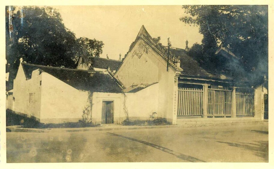 A building with a triangular roof and a gated entrance. 3