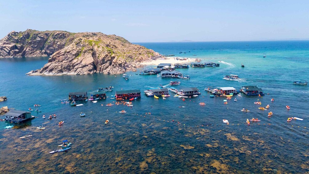 A coastal area with boats and people engaging in water activities. 5