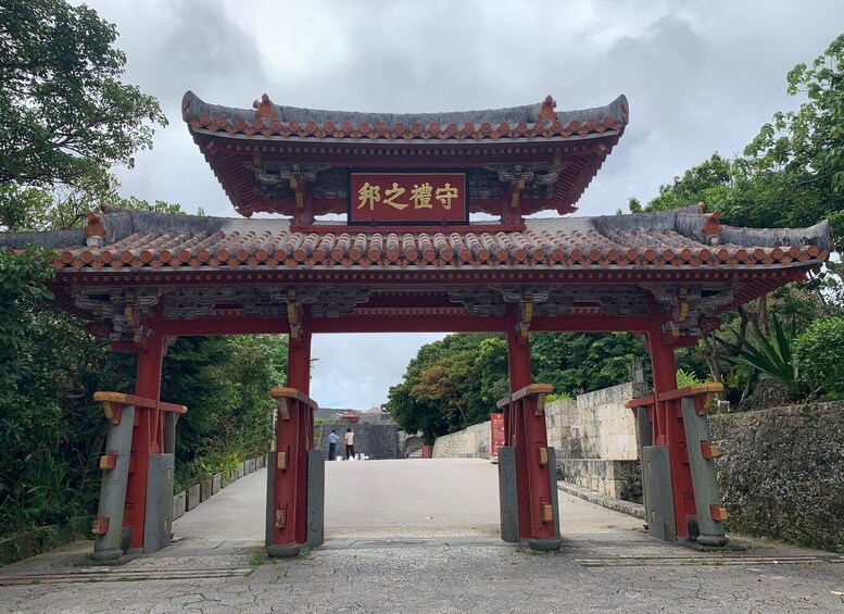 A traditional Chinese gate with intricate roof design and a signboard. 1