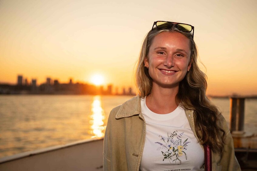 A person standing on a dock with a sunset in the background. 3