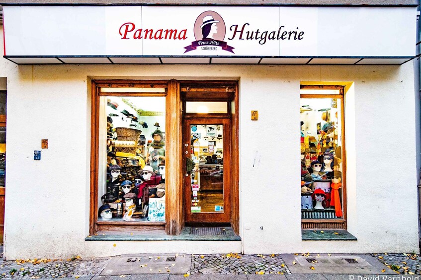A storefront named 'Panama Hutgalerie' with mannequins displaying hats and clothing. 2