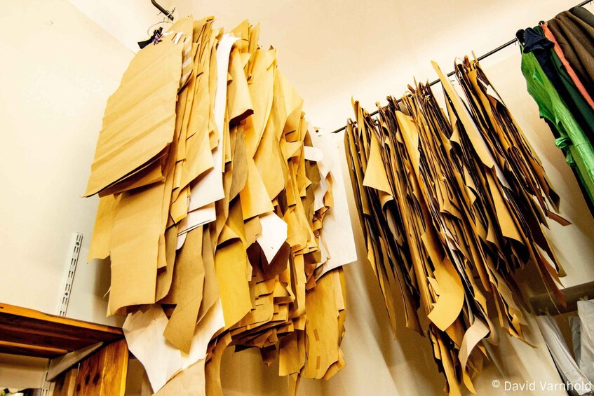 A room with various papers and documents hanging on a wall. 1