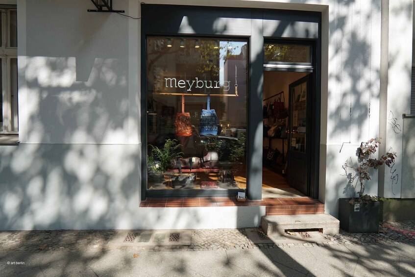 A storefront with the name 'meyburg' and a display of colorful items. 4