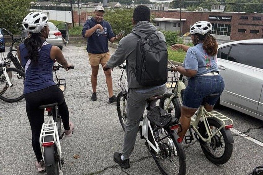 A group of people on bicycles in a parking lot. 5