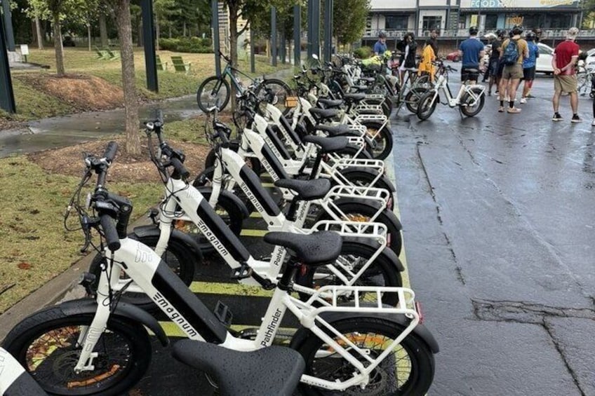 A row of dockless electric scooters parked along a sidewalk. 4