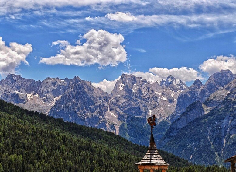 A mountain range with a wooden structure on a hill. 4