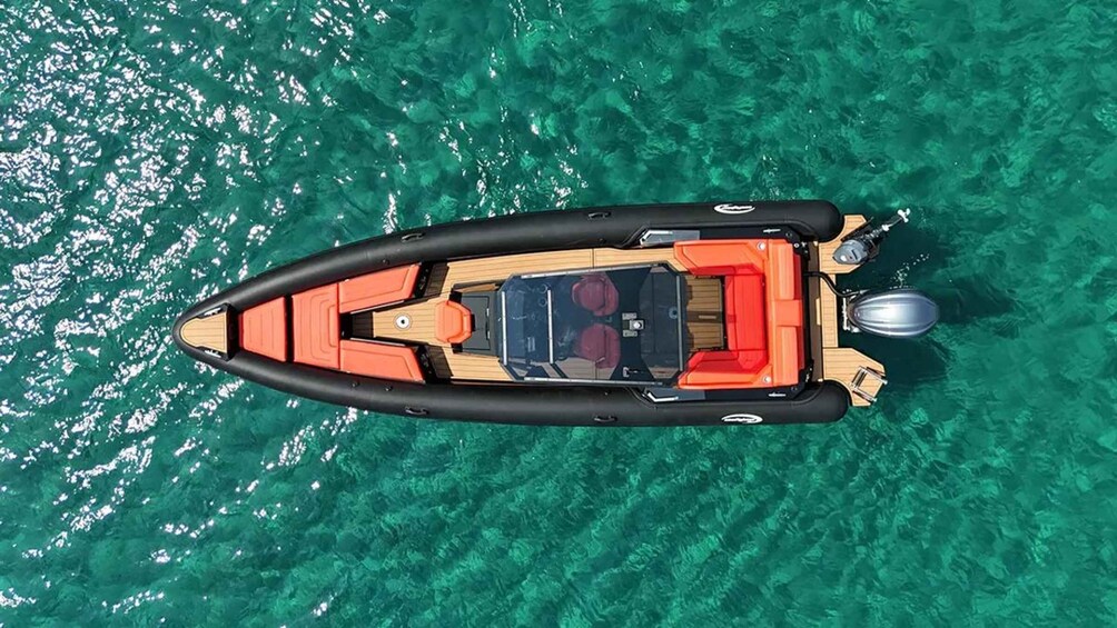 An inflatable boat on clear turquoise water. 2