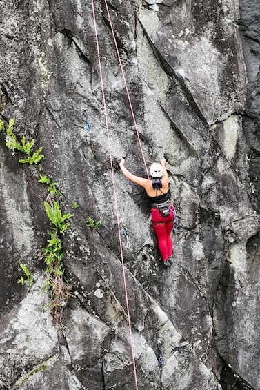A person rock climbing on a rugged cliff. 1