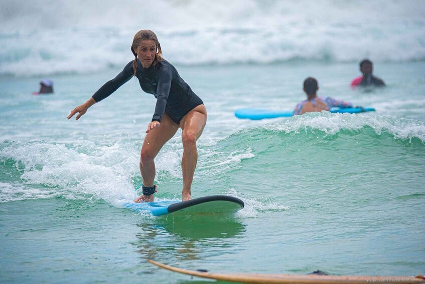 A person surfing on a wave in the ocean. 4