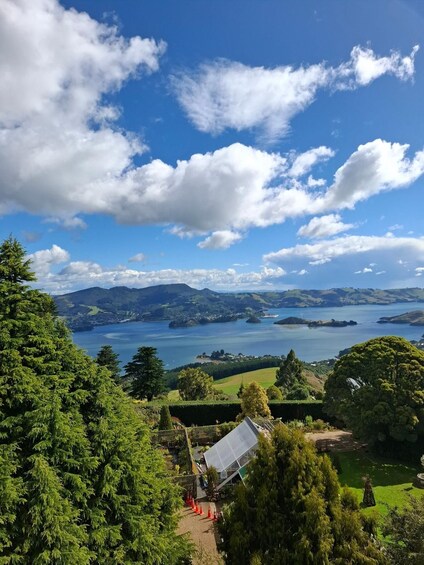 A coastal landscape with a clear sky, a body of water, and a distant mountain range. 2