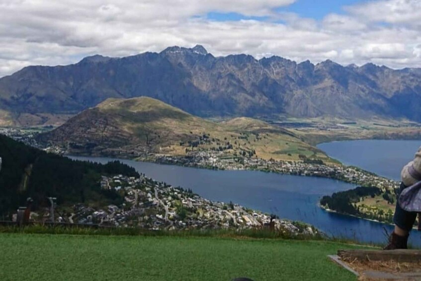 A mountainous landscape with a lake and a small town. 1