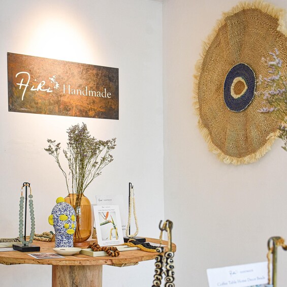 A display of handmade crafts including jewelry and a wall hanging. 4
