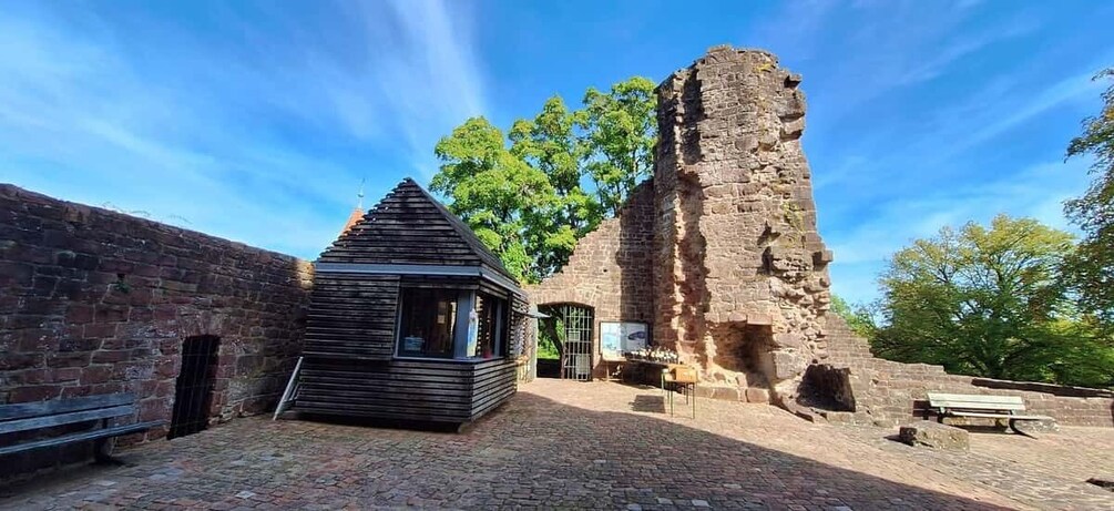 A historical stone structure with a wooden building in front. 4
