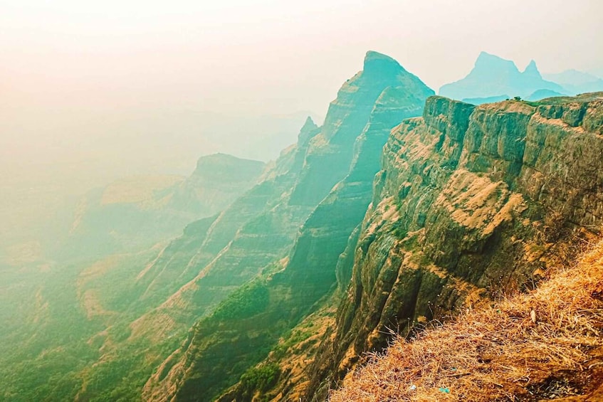 A mountainous landscape with steep cliffs and a valley. 2