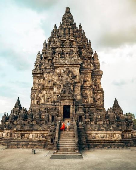 A large, ancient stone temple with multiple tiers and a central doorway. 3