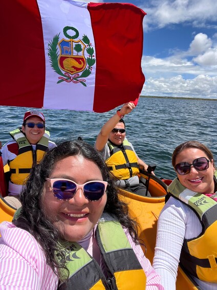 A group of people in a canoe on a body of water, with one person holding a flag. 2