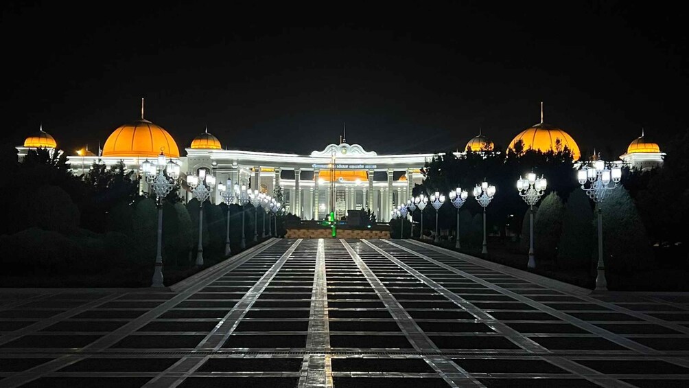 A grand building with multiple domed structures, a central entrance, and a symmetrical arrangement of street lamps. 3