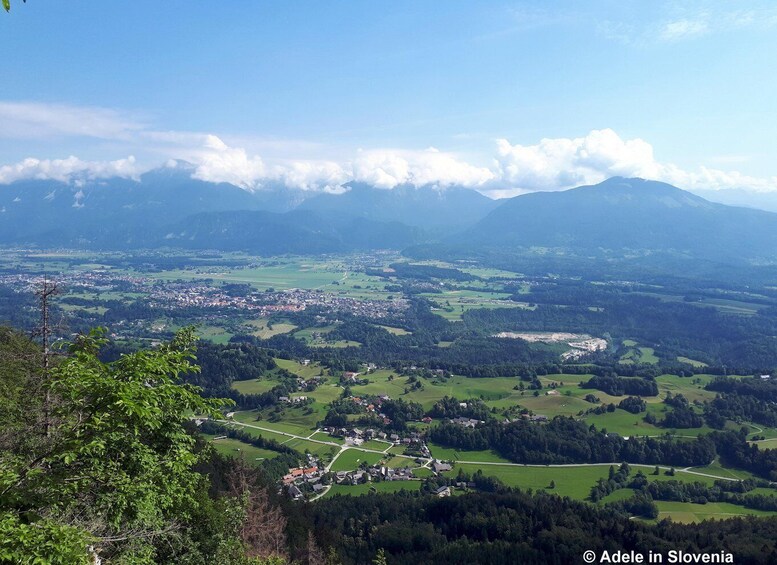 A panoramic view of a town nestled in a valley with mountains in the background. 3