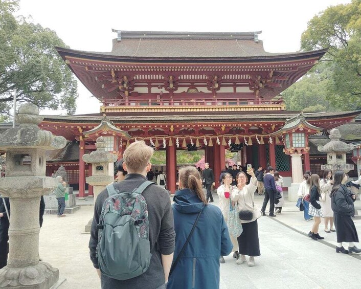 A traditional Japanese temple with a large red gate and stone lanterns. 4