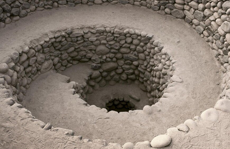 A spiral stone structure with a central opening. 1