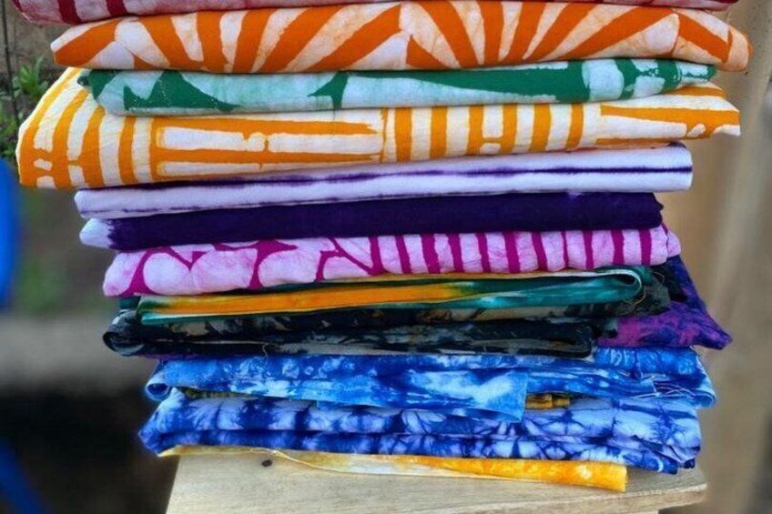 A stack of colorful folded fabrics. 5