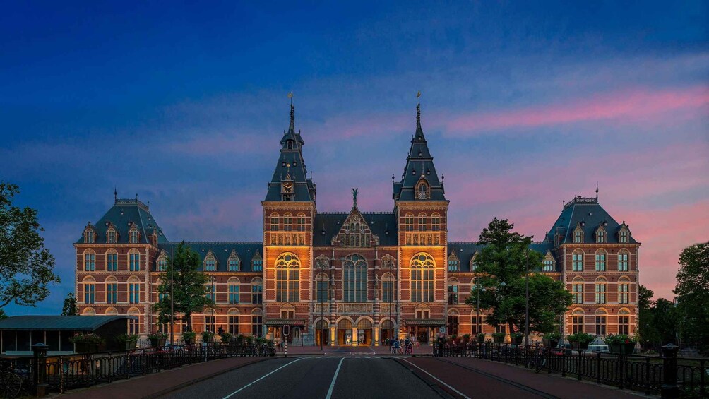 A large, historic building with two prominent towers and a central entrance. 3