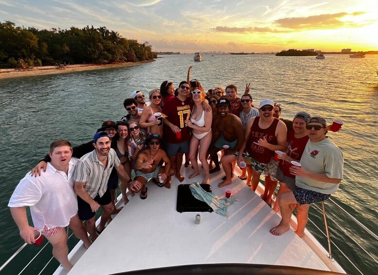 A group of people on a boat with a sunset in the background. 3