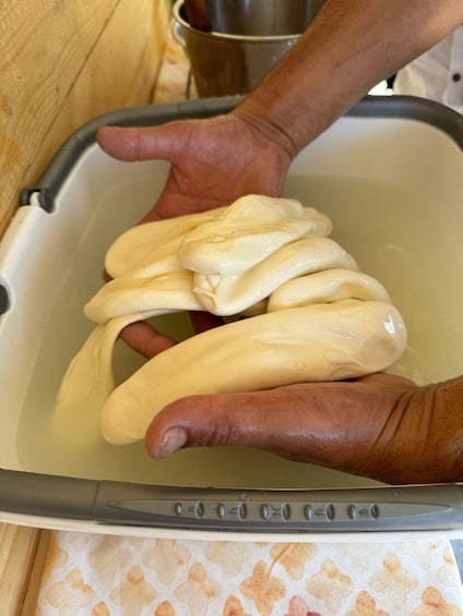 Hands holding dough in a kitchen sink. 3