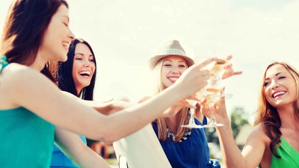 A group of people toasting with champagne glasses. 3
