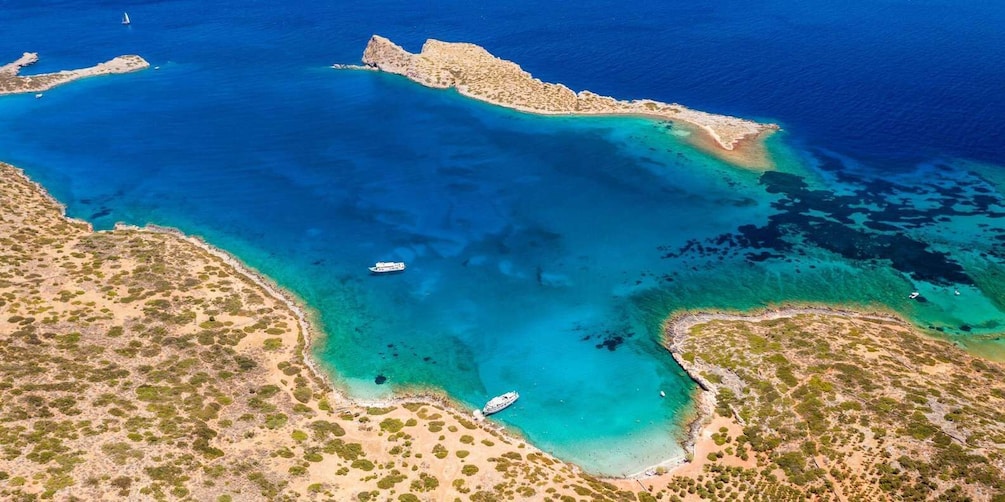 An aerial view of a coastal area with clear blue waters, sandy beaches, and scattered vegetation. 5