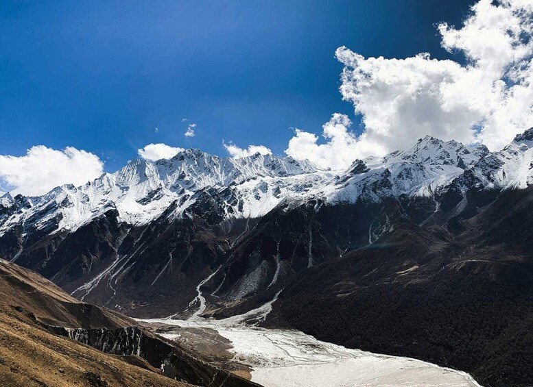 A snow-covered mountain range with a glacier. 1