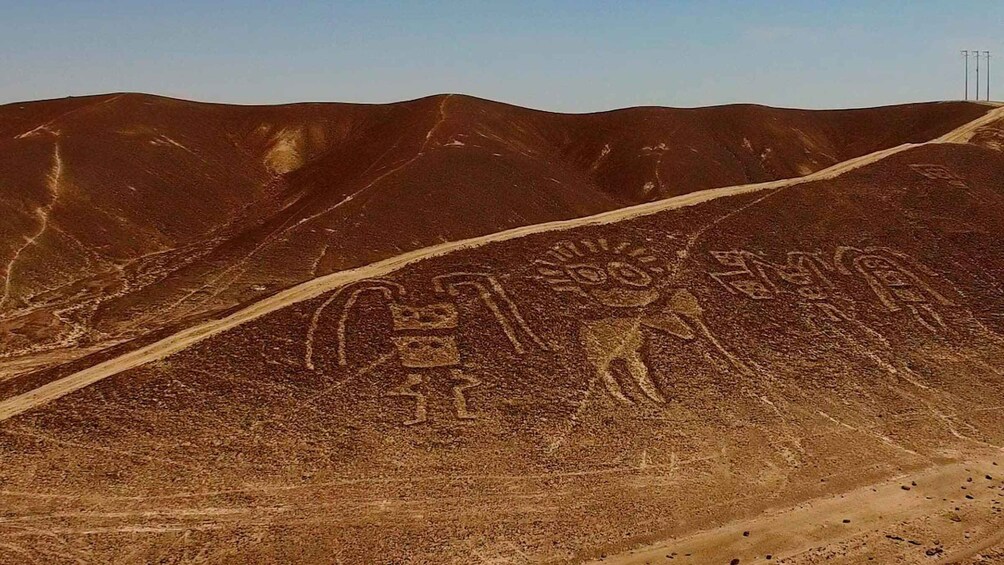 A desert landscape with ancient petroglyphs carved into the hills. 1