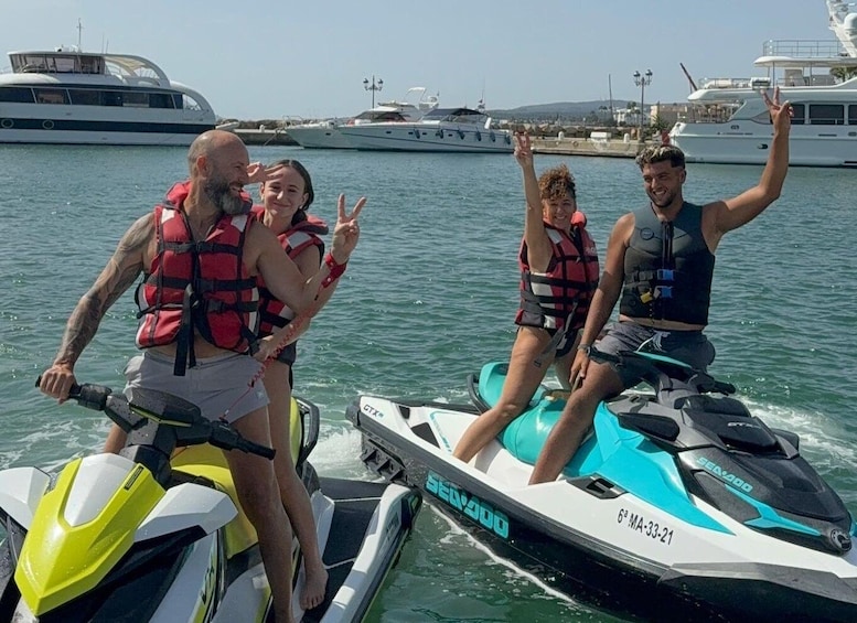 Four people on a Sea-Doo jet ski, wearing life jackets, with a marina and yachts in the background. 1