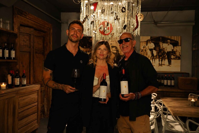A group of people in a dimly lit room with wooden furniture and a chandelier. 2