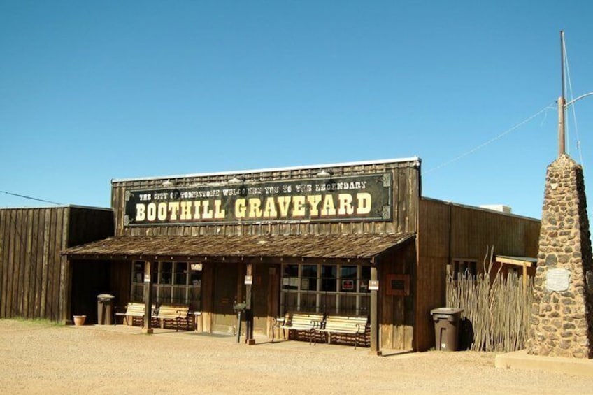 A wooden building with a sign reading 'BOOTHILL GRAVEYARD.' 5