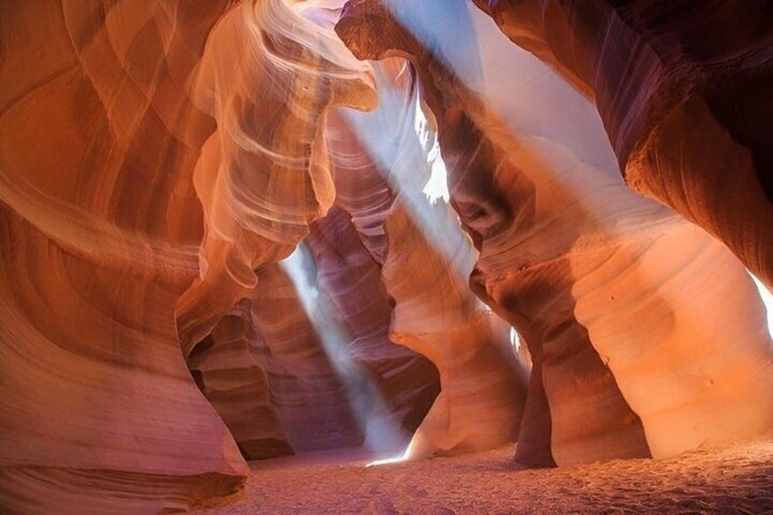 A canyon with smooth, curved rock formations and a narrow passageway. 2