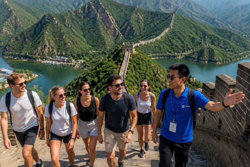 A group of people walking on the Great Wall of China with a mountainous landscape in the background. 3