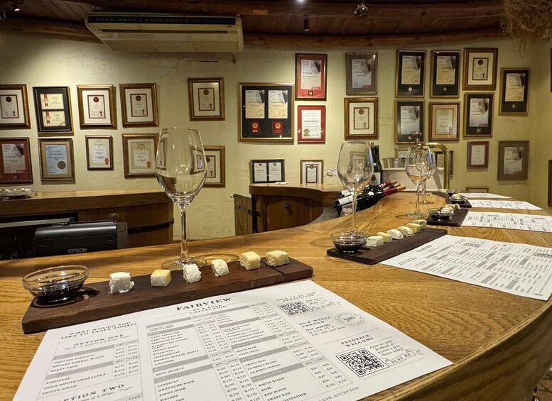 A wine tasting room with a wooden counter, wine glasses, and a menu. 3