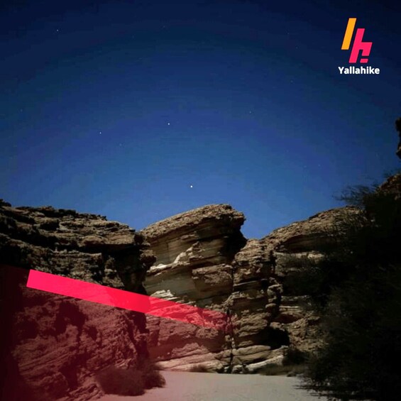 A canyon with layered rock formations and a clear night sky. 2