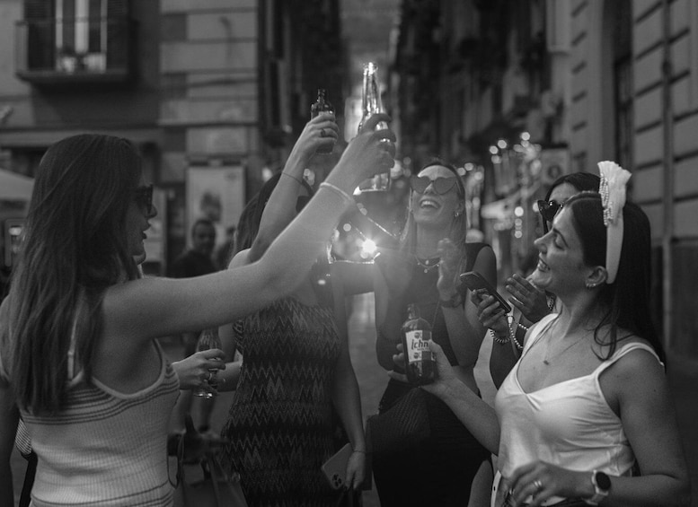 A group of people toasting with champagne glasses in an urban setting. 2