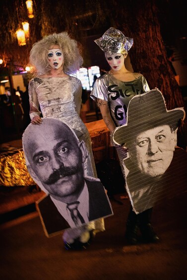 Two people in costumes with large cutouts of faces. 5