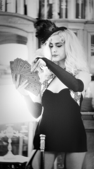 A person holding playing cards. 4