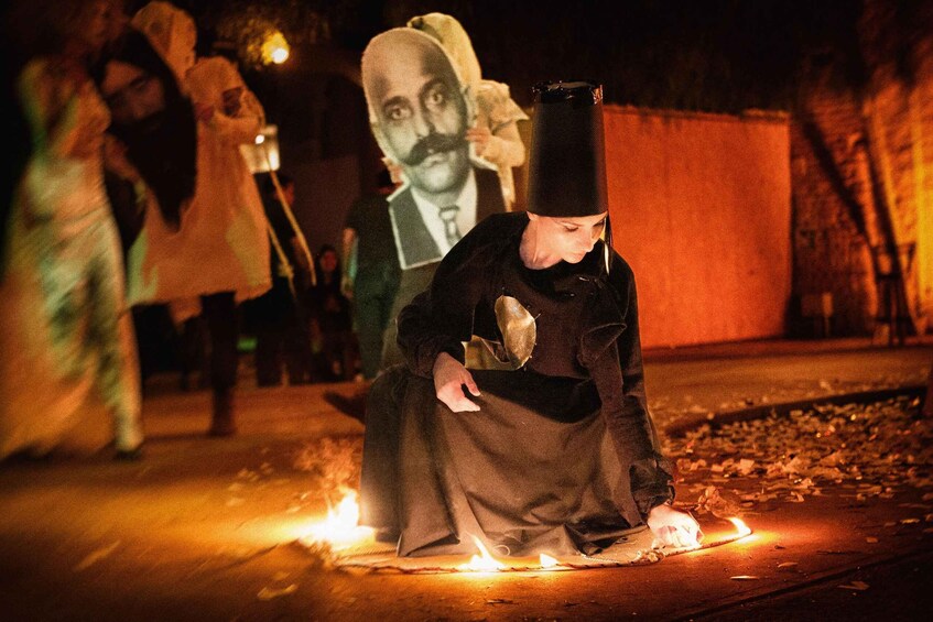 A person sitting on the ground with a light source in front of them. 3